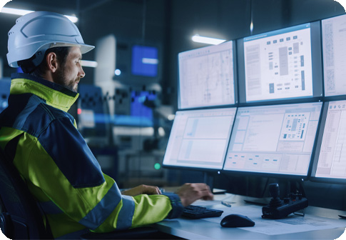 worker looking at computer monitors