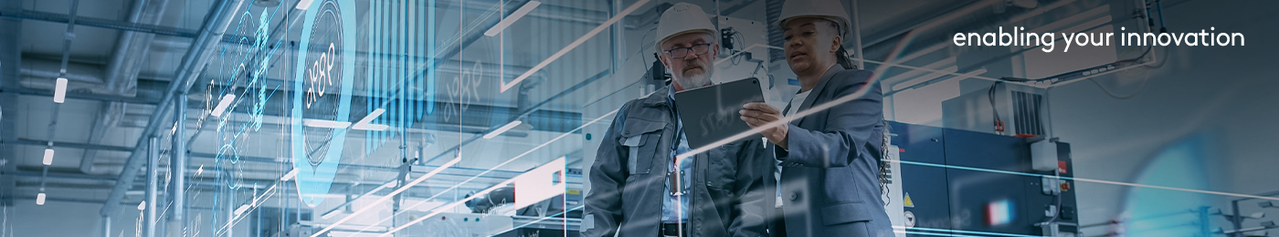 Two managers at a production floor looking at digitized production plans 