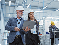 Two Professional Heavy Industry Engineers Wearing Hard Hats at Factory.